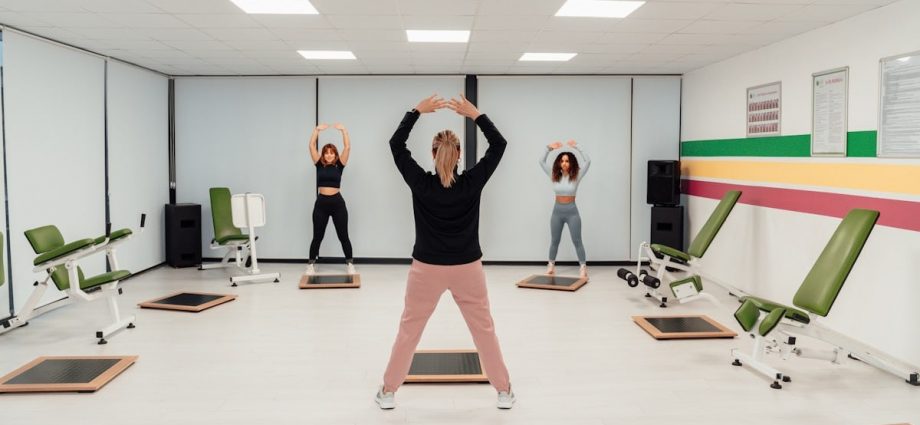 a group of people doing exercises in a room
